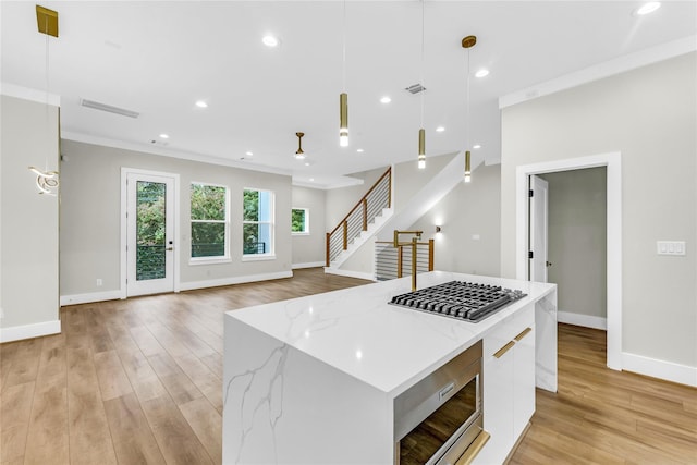 602 W 28th St Unit B, Houston, TX 77008 - kitchen featuring white cabinets, appliances with stainless steel finishes, modern cabinets, and light wood-style flooring