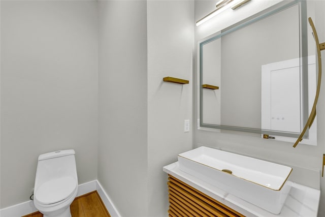 602 W 28th St Unit B, Houston, TX 77008 - half bath with vanity, toilet, wood finished floors, and baseboards