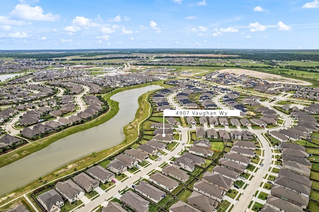 view of property location featuring nearby suburban area and a large body of water