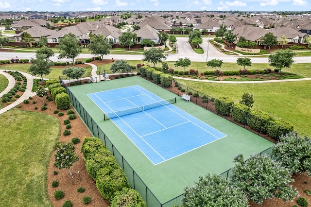 view of tennis court featuring a residential view