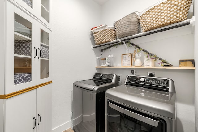 laundry area featuring washing machine and dryer and baseboards