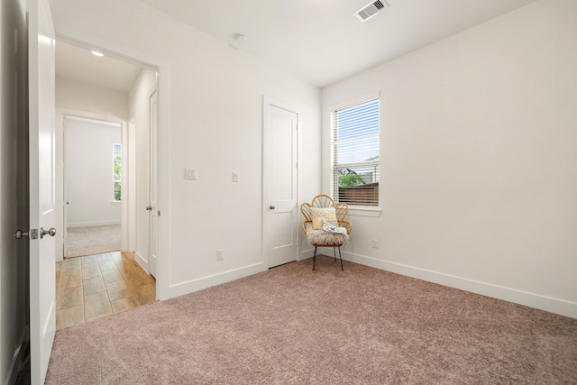 carpeted empty room featuring plenty of natural light and baseboards