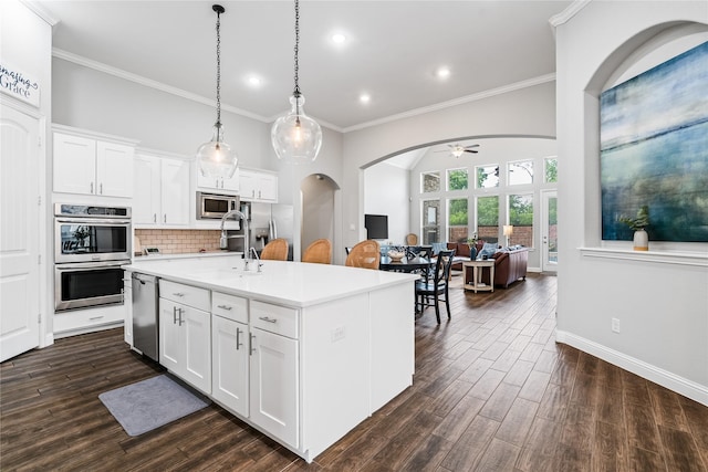 kitchen featuring stainless steel appliances, ornamental molding, recessed lighting, light countertops, and a ceiling fan