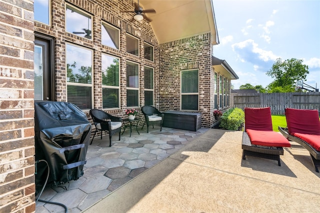 view of patio with a ceiling fan, a grill, and fence