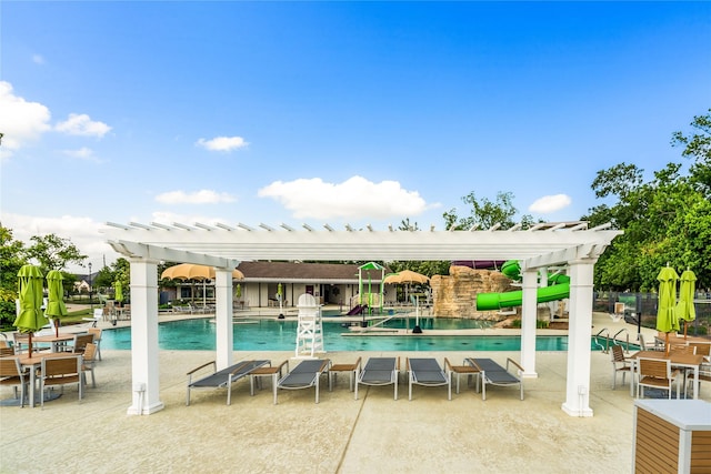 community pool with a patio and a pergola