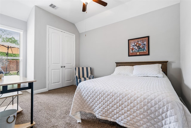 carpeted bedroom with a closet, visible vents, vaulted ceiling, ceiling fan, and baseboards