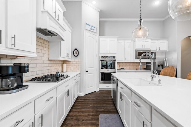 kitchen featuring a sink, stainless steel appliances, ornamental molding, light countertops, and white cabinets