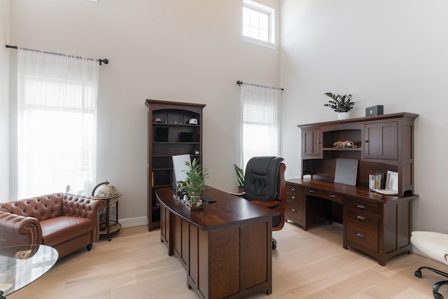 3923 Kelley Pond Dr, Spring, TX 77386 - office area featuring light wood-style flooring and a towering ceiling