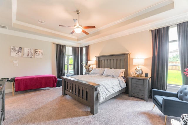 3923 Kelley Pond Dr, Spring, TX 77386 - carpeted bedroom featuring a tray ceiling, crown molding, visible vents, and a ceiling fan