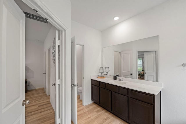 908 Pickering Oak Row, Magnolia, TX 77354 - bathroom with toilet, vanity, visible vents, and wood finished floors