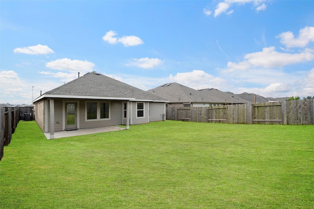 908 Pickering Oak Row, Magnolia, TX 77354 - back of house with a lawn, a patio area, roof with shingles, and a fenced backyard
