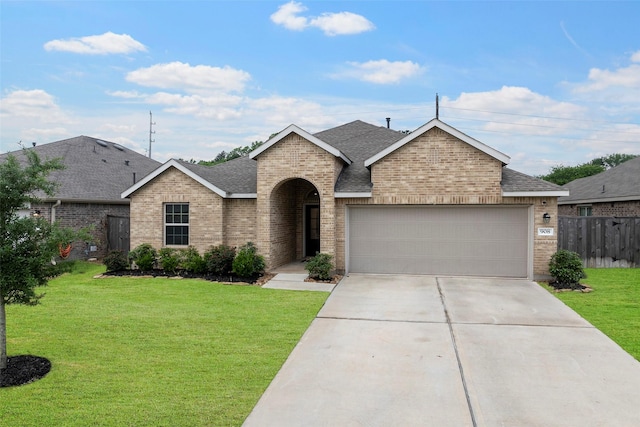 908 Pickering Oak Row, Magnolia, TX 77354 - view of front of house with an attached garage, fence, a shingled roof, and brick siding
