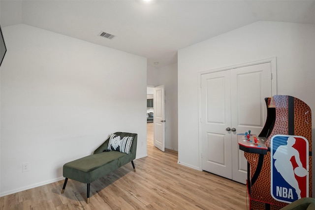 908 Pickering Oak Row, Magnolia, TX 77354 - living area featuring baseboards, vaulted ceiling, light wood-style flooring, and visible vents