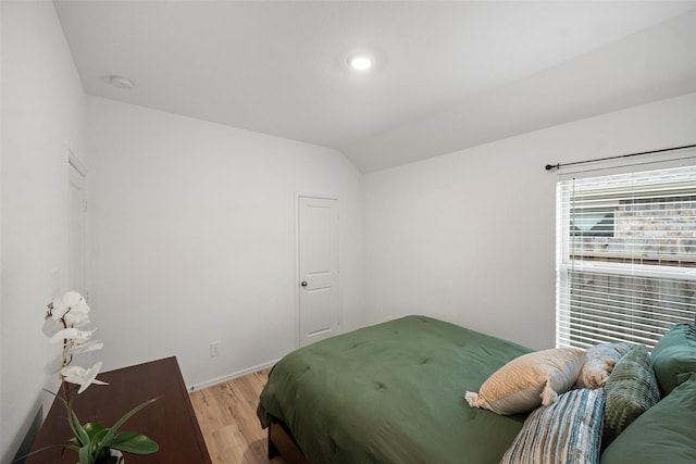908 Pickering Oak Row, Magnolia, TX 77354 - bedroom featuring light wood-style floors, vaulted ceiling, and baseboards