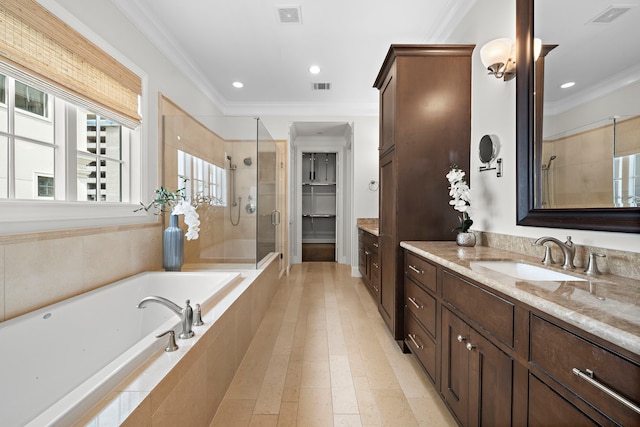 5412 Jackson St, Houston, TX 77004 - full bathroom featuring vanity, a shower stall, a garden tub, crown molding, and recessed lighting