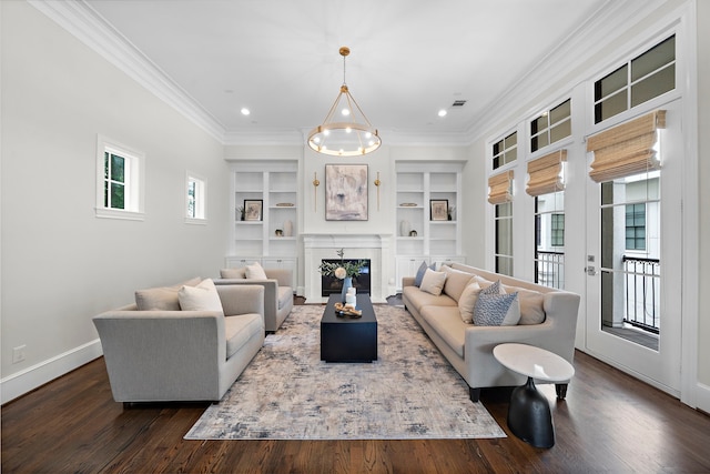 5412 Jackson St, Houston, TX 77004 - living room with ornamental molding, built in features, dark wood finished floors, baseboards, and a glass covered fireplace
