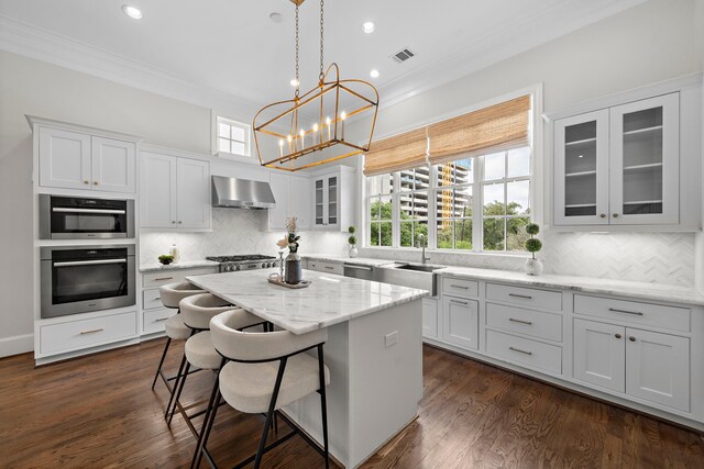 5412 Jackson St, Houston, TX 77004 - kitchen featuring ventilation hood, a sink, ornamental molding, white cabinets, and a kitchen island