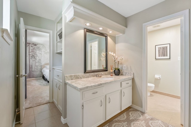 6615 Ampton Dr, Spring, TX 77379 - ensuite bathroom with vanity, tile patterned flooring, toilet, and baseboards