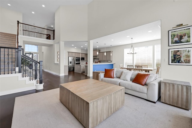 437 Ripple Edge Ct, Katy, TX 77493 - living area featuring plenty of natural light, a towering ceiling, stairway, recessed lighting, and light wood finished floors