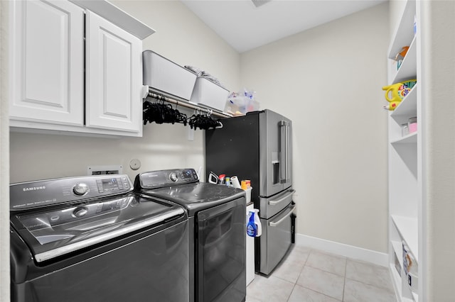437 Ripple Edge Ct, Katy, TX 77493 - laundry area with separate washer and dryer, cabinet space, light tile patterned floors, and baseboards