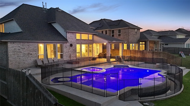 437 Ripple Edge Ct, Katy, TX 77493 - view of pool with a patio, a fenced backyard, a fire pit, and a pool with connected hot tub