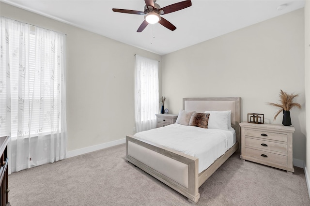 437 Ripple Edge Ct, Katy, TX 77493 - bedroom featuring multiple windows, light carpet, baseboards, and ceiling fan