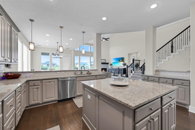 437 Ripple Edge Ct, Katy, TX 77493 - kitchen with gray cabinets, dishwasher, a sink, dark wood-style floors, and recessed lighting