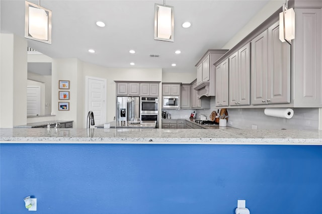 437 Ripple Edge Ct, Katy, TX 77493 - kitchen featuring appliances with stainless steel finishes, gray cabinets, recessed lighting, light stone countertops, and a peninsula