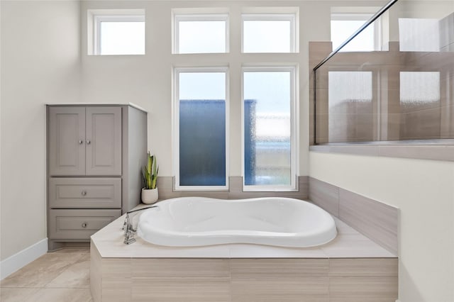 437 Ripple Edge Ct, Katy, TX 77493 - bathroom with a garden tub, a tile shower, and baseboards