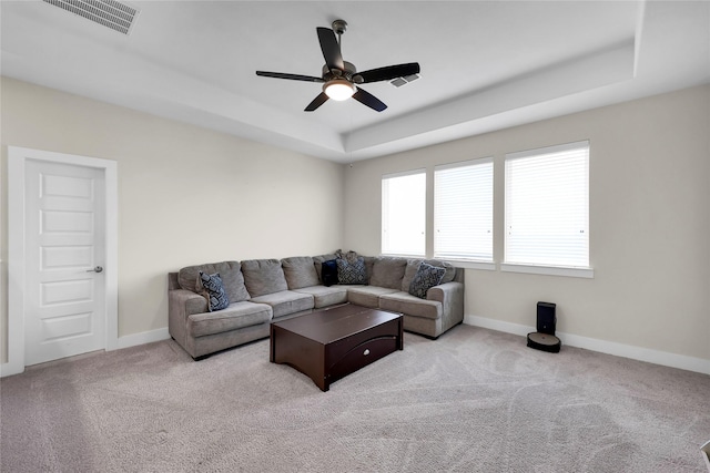 437 Ripple Edge Ct, Katy, TX 77493 - carpeted living room with a raised ceiling, a ceiling fan, and baseboards