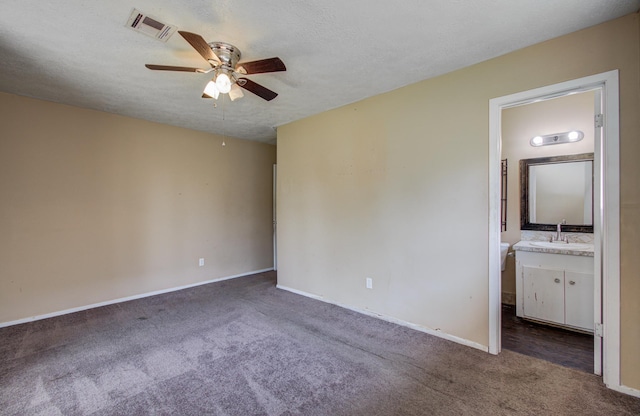unfurnished bedroom featuring carpet, visible vents, baseboards, and a sink