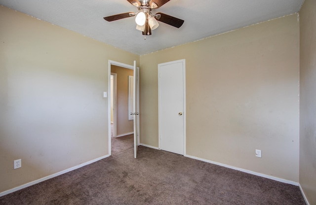 unfurnished room with carpet, baseboards, and a ceiling fan