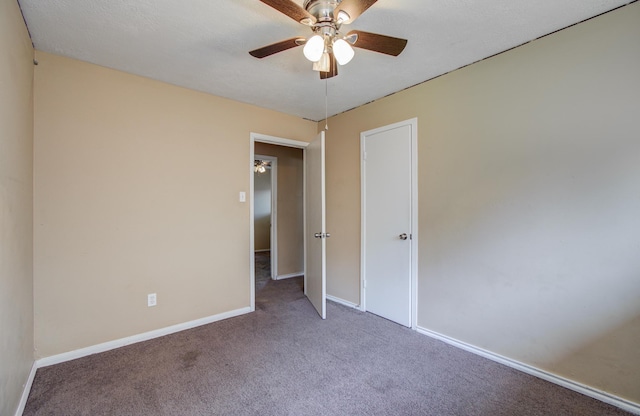 unfurnished bedroom with baseboards, ceiling fan, and carpet floors