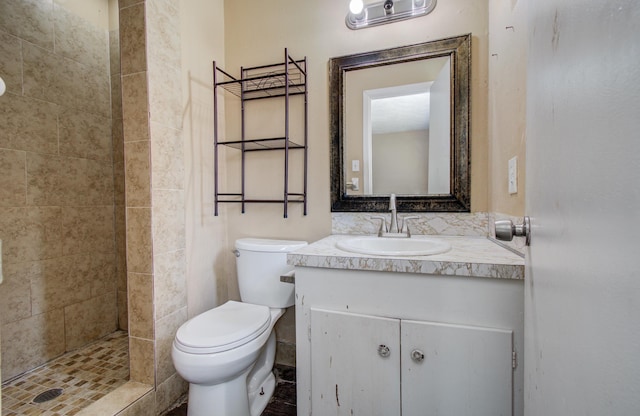 full bathroom featuring a shower stall, vanity, and toilet