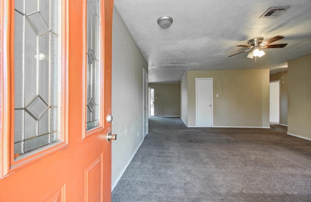 spare room featuring ceiling fan, carpet flooring, baseboards, and visible vents