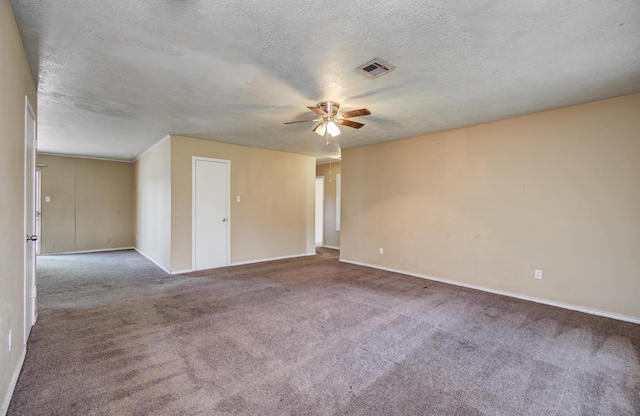 carpeted spare room with a textured ceiling, visible vents, baseboards, and a ceiling fan