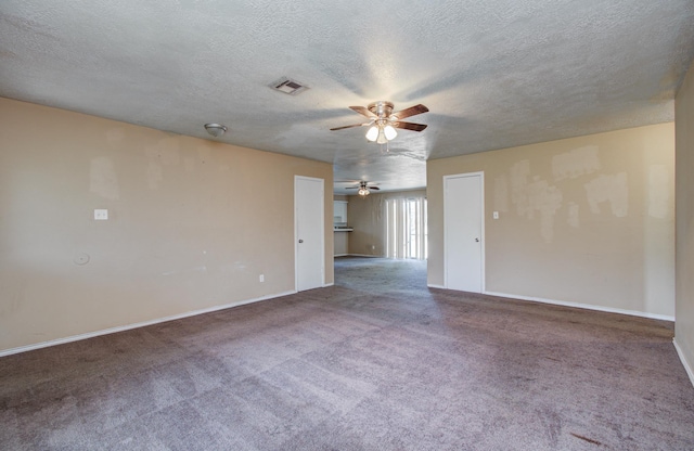 carpeted empty room with a ceiling fan, baseboards, visible vents, and a textured ceiling