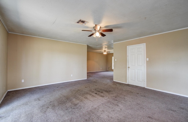spare room featuring carpet flooring, baseboards, a ceiling fan, and visible vents