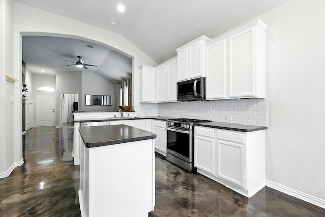 15226 Loys Coves Ct, Humble, TX 77396 - kitchen featuring stainless steel range with gas stovetop, vaulted ceiling, backsplash, concrete flooring, and recessed lighting