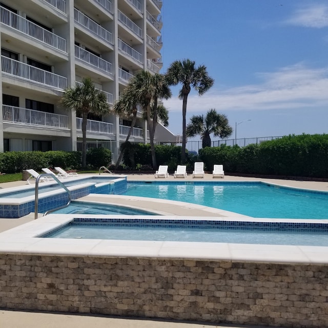 7700 Seawall Blvd Unit 402, Galveston, TX 77551 - community pool featuring a hot tub