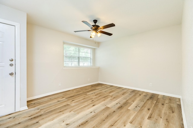 unfurnished room featuring baseboards, a ceiling fan, and wood finished floors