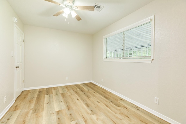 empty room with ceiling fan, baseboards, light wood-type flooring, and visible vents
