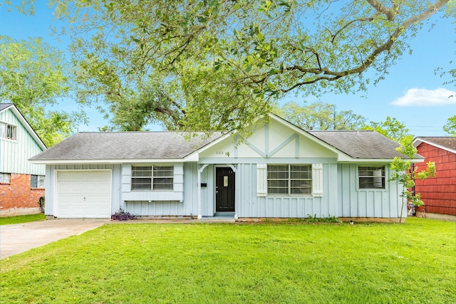 view of front facade with a garage, a shingled roof, board and batten siding, concrete driveway, and a front yard