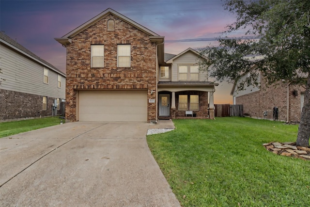 traditional-style home with fence, an attached garage, brick siding, a yard, and concrete driveway