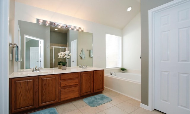 bathroom featuring double vanity, a stall shower, a sink, tile patterned floors, and a bath