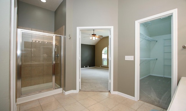 full bathroom with ceiling fan, baseboards, a shower stall, and tile patterned flooring