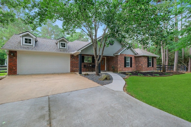 view of front of property featuring concrete driveway, brick siding, fence, and a front yard