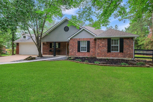 view of front facade with fence, a front yard, brick siding, and driveway