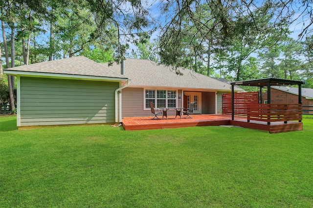back of house with roof with shingles, a wooden deck, french doors, and a lawn