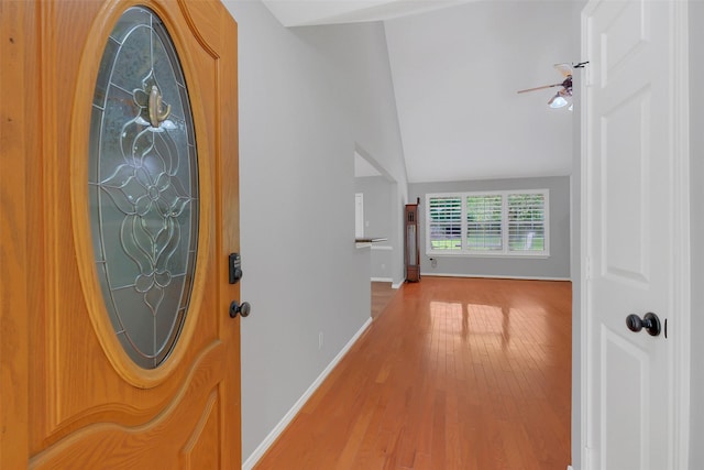 foyer entrance featuring baseboards, a ceiling fan, and wood finished floors